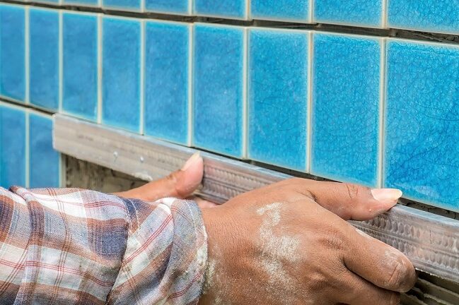 Contractor using spacer for installing tiles