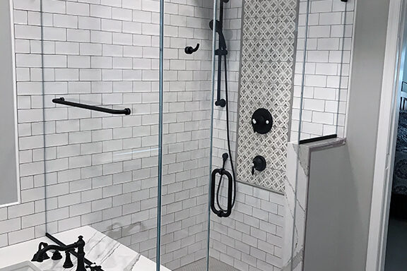 Panel door panel corner shower with a towel bar and robe hook in matte black