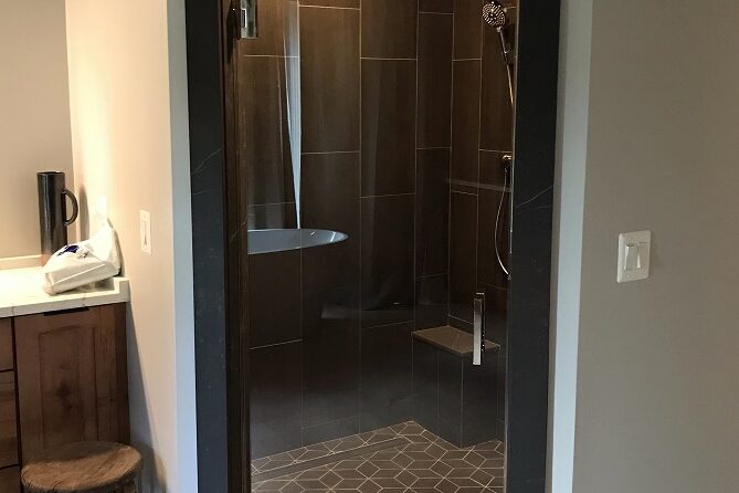 Swing glass door to wet room shower enclosure