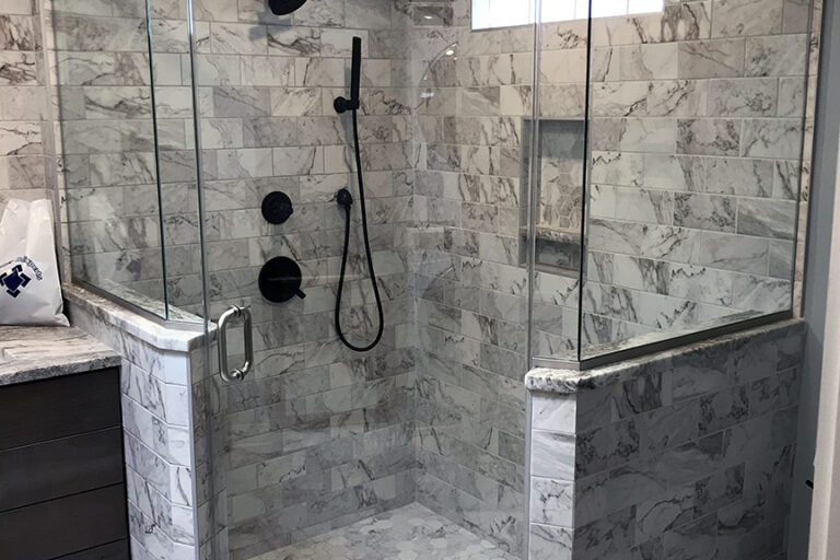 frameless swing shower enclosure with a metal header in Catonsville Maryland