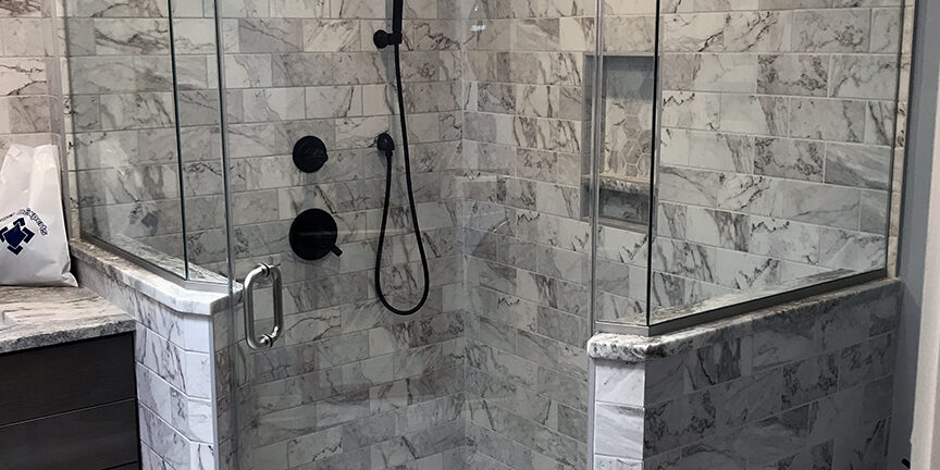 frameless swing shower enclosure with a metal header in Catonsville Maryland