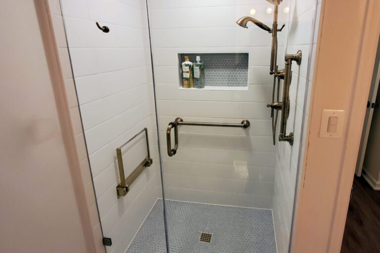 Shower door with custom brushed bronze hardware