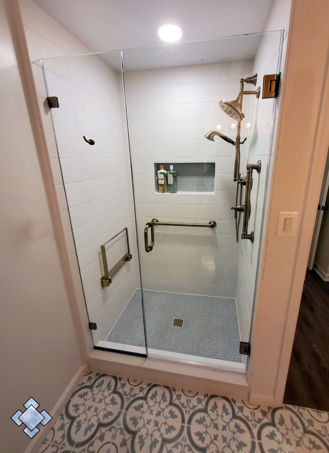 Shower door with custom brushed bronze hardware
