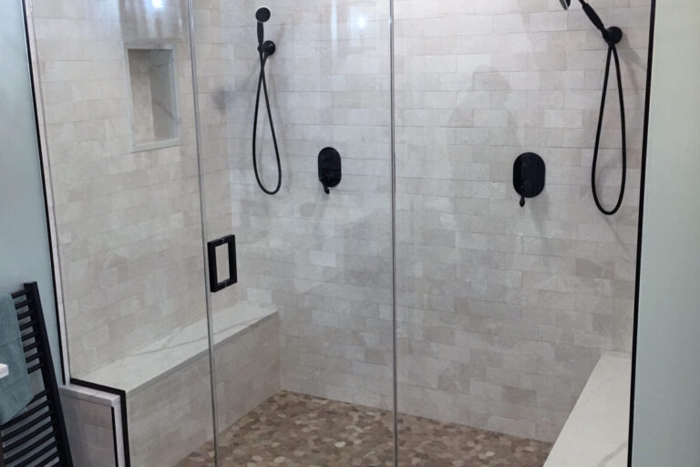 Shower door with oil rubbed bronze hardware and header