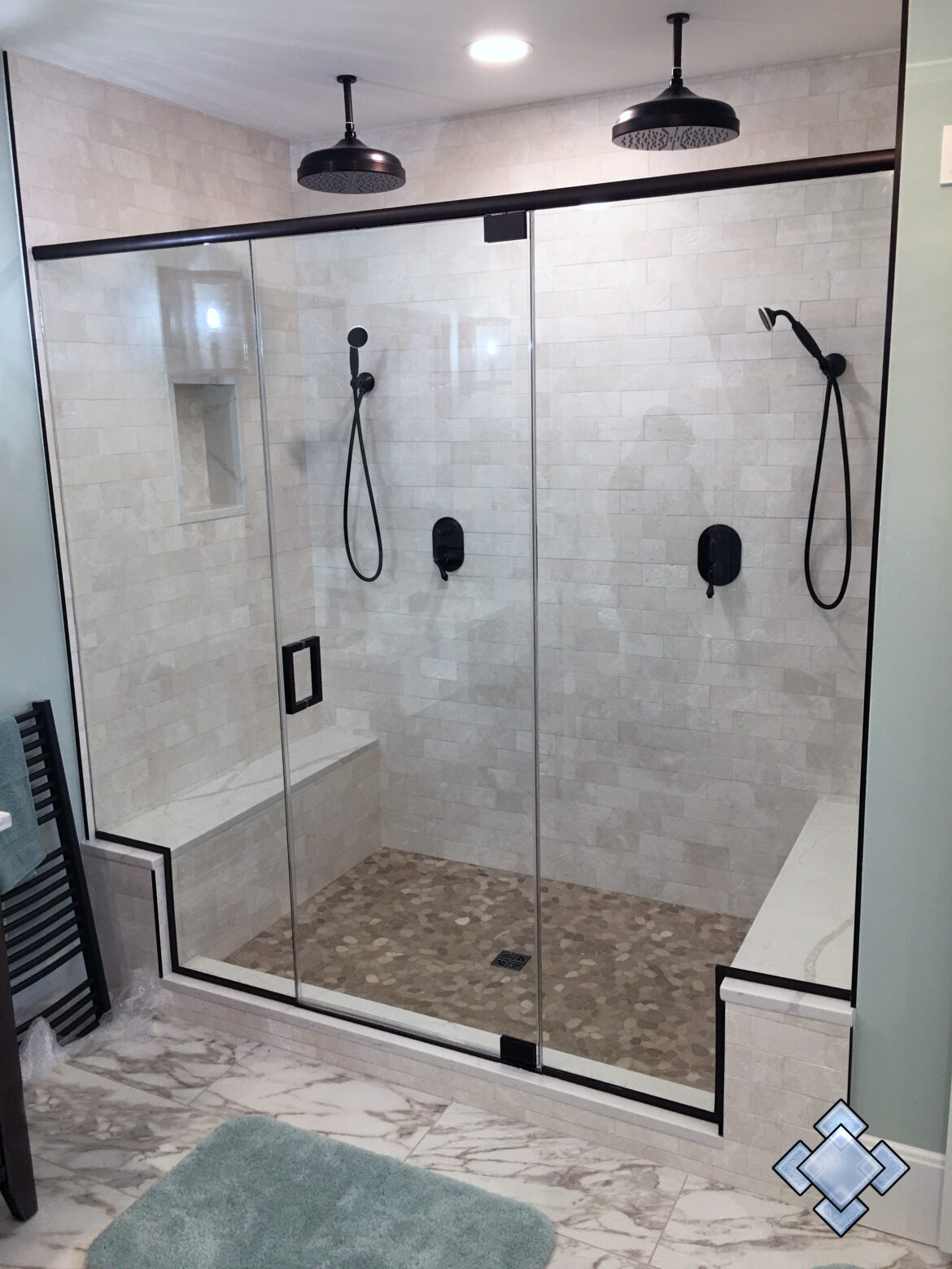 Shower door with oil rubbed bronze hardware and header