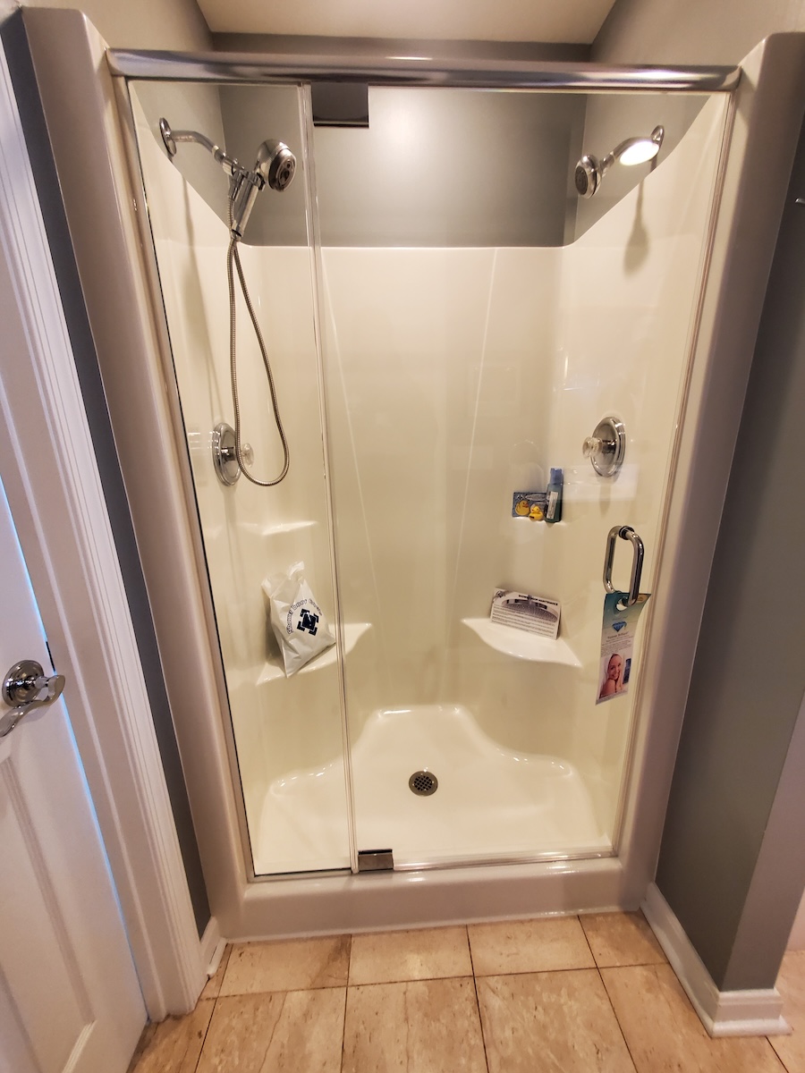 frameless shower door with header on fiberglass surround in Williamsport, MD