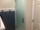 Small hallway bathroom shower door and panel with acid etch glass